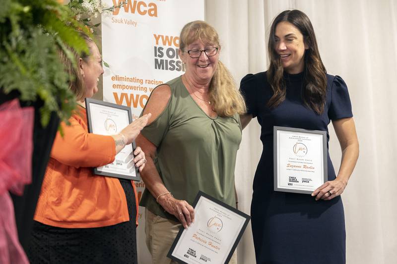Patricia Hunter (center) reacts to being names the recipient of the Pearl Woods Award for Business and Industry Thursday, April 17, 2025, during the YWCA’s Women of Achievement Luncheon.