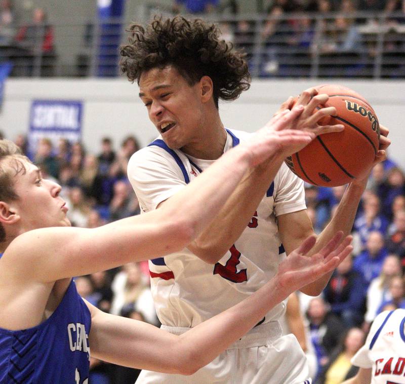 Burlington Central’s Jake Johnson, left, guards Marmion Academy’s Jabe Haith in IHSA Class 3A Sectional title game action at Burlington Central High School Friday night.