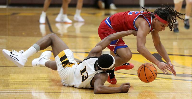 Jacobs' Elijah Bell battles with Dundee-Crown's Anthony Spain for a loose ball during a Fox Valley Conference boys basketball game on Tuesday, February. 3, 2026, at Jacobs High School in Algonquin.