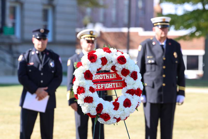 A wreath awaits placement at the memorial wall during the 44th Kankakee County Fallen Firefighter Memorial Service on Friday, Oct. 3, 2025.