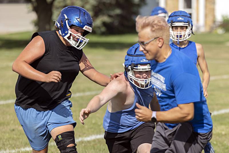 Newman players run through drills during first day of football practice Monday, August 7, 2023.