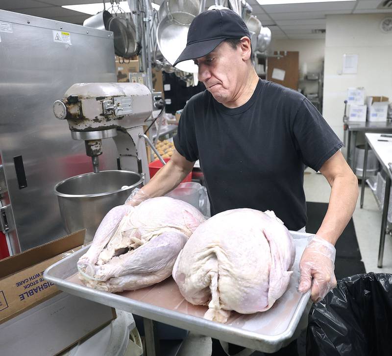 Gustavo Lepez, kitchen supervisor for the Voluntary Action Center, brings turkeys to the oven at the facility in Sycamore Thursday, Nov. 17, 2022, as they prepare Thanksgiving meals to be delivered to clients. The Thanksgiving meals were payed for through a donation from the family of Don "Tank" Anderson. VAC delivers meals to the home bound and elderly along with providing transportation options.