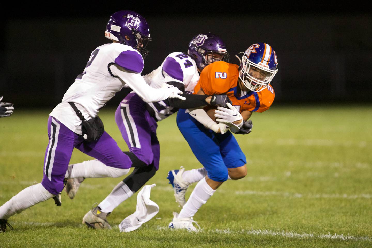 Genoa - Kingston's Traven Atterberry is tackled by Dixon's Hunter Vacek (24) and Jathaniel St Pier (2) on Friday Oct.7,2022 in Genoa.