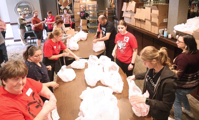 Volunteers help package boxes of food for the 27th annual Lighted Way Spaghetti Dinner on Monday, April 20. 2025 at Uptown downtown La Salle.