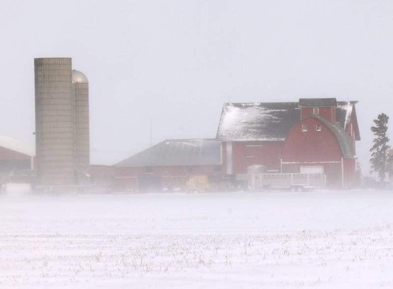 Blowing snow obscures a barn Monday, March 16, 2026, just south of Hinckley. A March snowfall covered DeKalb County in about six inches of the white stuff Sunday night into Monday.