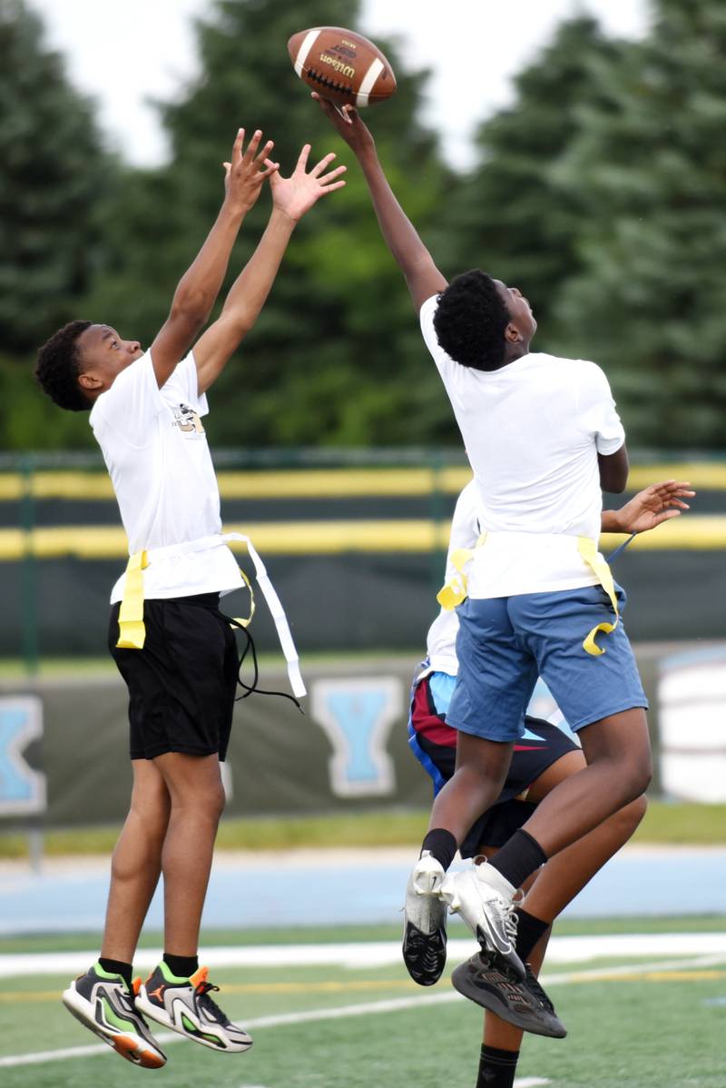 Mashawi Boyd, 12, of Kankakee, tips a pass intended for fellow 12-year-old Kankakee resident Kendal Bryson during a game of 7-on-7 during the sixth annual Jonathan Ward Skills Camp at Kankakee High School Saturday, June 14, 2025.