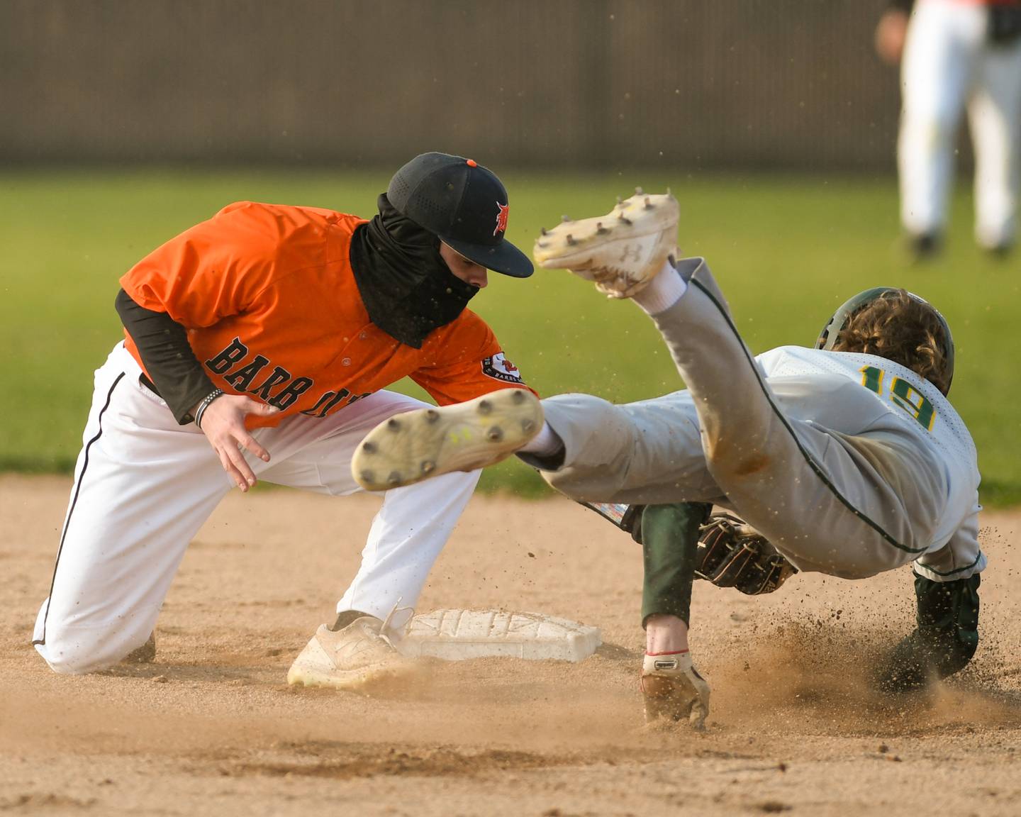 DeKalb Nik Nelson (3) tags out Waubonsie Valley Nicholas Martin (19) during the game on Tuesday April 25th held at DeKalb High School.