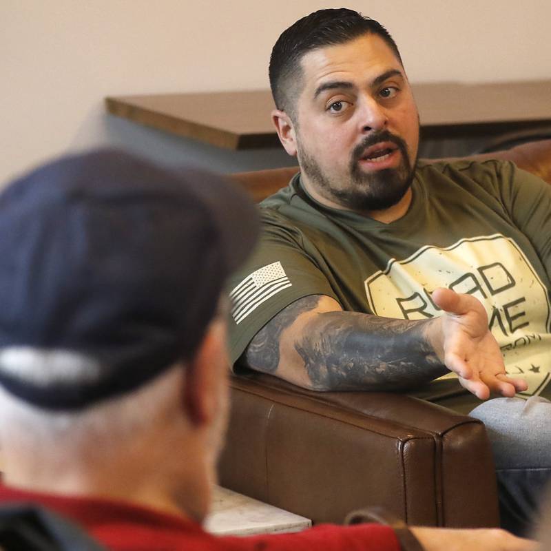 Mathius Carter talks with another veteran on Friday, March 8, 2024, at the Other Side in Crystal Lake, during a meeting of area veterans. Veterans meeting and talking about their feelings and sharing camaraderie is important in combating veteran's suicide according to experts.