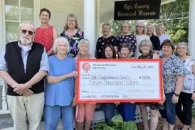 100 Women for Care of Ogle County donate to Ogle County Historical Society