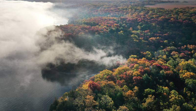 Fog begins to lift from the Illinois River between the top of Starved Rock and Eagle Cliff on Thursday, Oct. 24, 2024 in Starved Rock State Park.