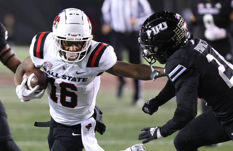 Ball State's Qian Magwood fends off Northern Illinois' Jashon Prophete during their game Tuesday, Nov. 7, 2023, in Huskie Stadium at NIU in DeKalb.