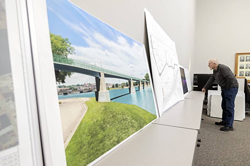 Larry Berkenpas of Dixon looks over plans and renderings on display Tuesday, Nov. 28, 2023 of the multi-use path and bridge in Dixon.