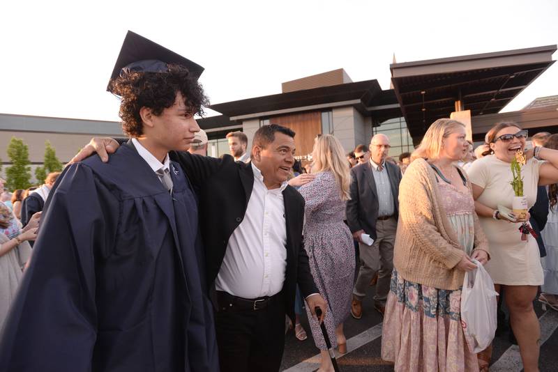 Nazareth graduate Alfredo Toledo of Cicero receives a hug and embrace from his dad, Alfredo Toledo, following the mass and graduation held on Sunday, May 18, 2025 at Christ Church of Oak Brook.
