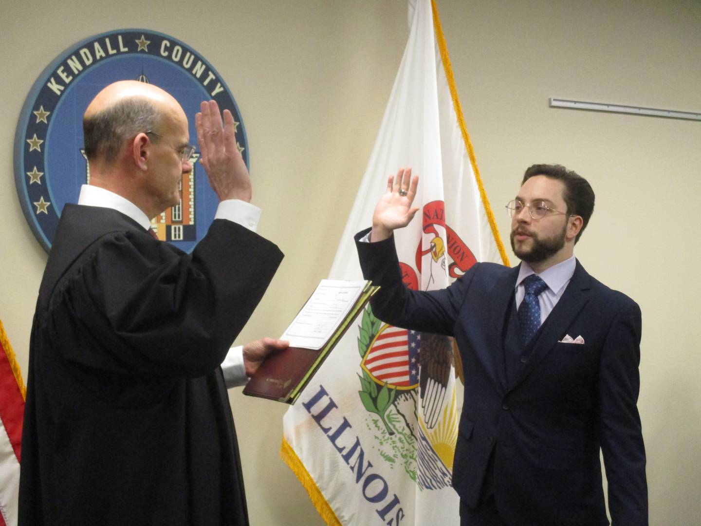 Newly elected Kendall County Board member Zach Bachmann takes the oath of office from Kendall County Presiding Judge Stephen Krentz on Dec. 5, 2022.