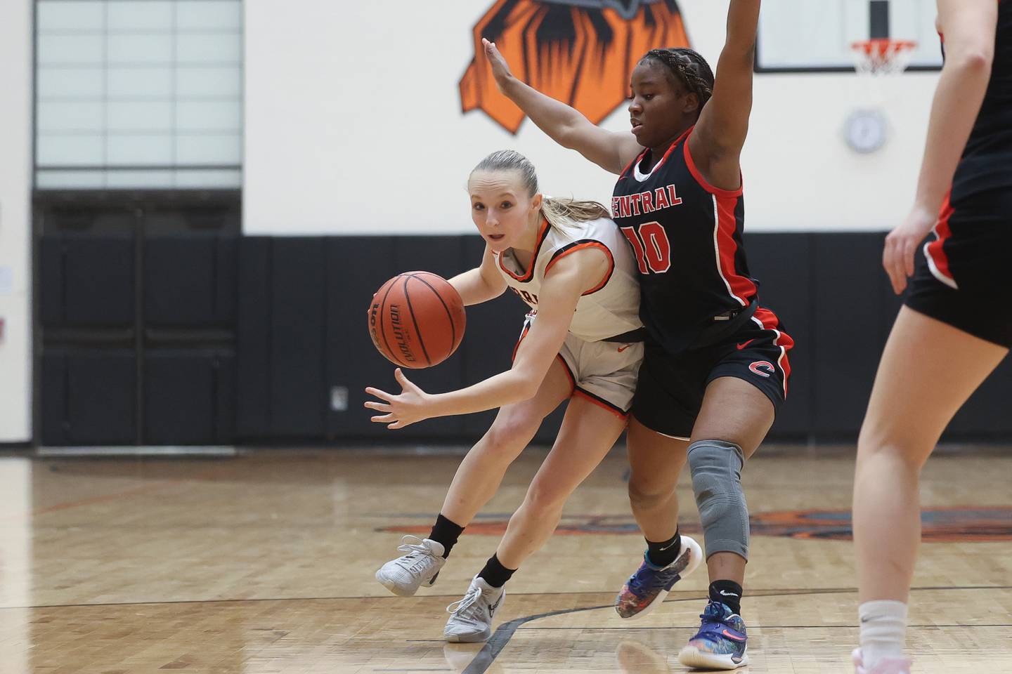 Lincoln-Way West’s Peyton Madl gets low around Lincoln-Way Central’s Kiya Newson-Cole on Monday, Jan. 22nd, 2024 in New Lenox.