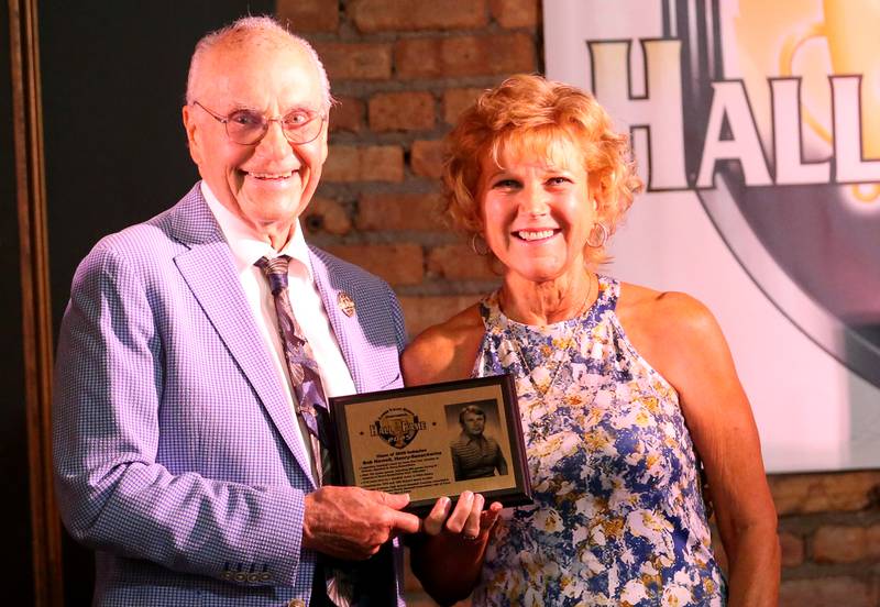LeeAnn Meinhold daughter of legendary Henry-Senachwine baseball coach Bob Newell, poses with emcee Lanny Slevin during the 2025 Shaw Media Illinois Valley Sports Hall of Fame at the Auditorium Ballroom in La Salle.