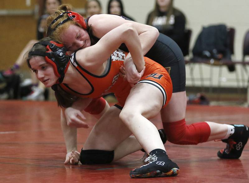 Morris’ Makensi Martin tries to control DeKalb’s RaeAnne Sciabaras in the 115-pound match of a nononference wrestling meet on Wednesday, Jan. 22, 2025, at Huntley High School.