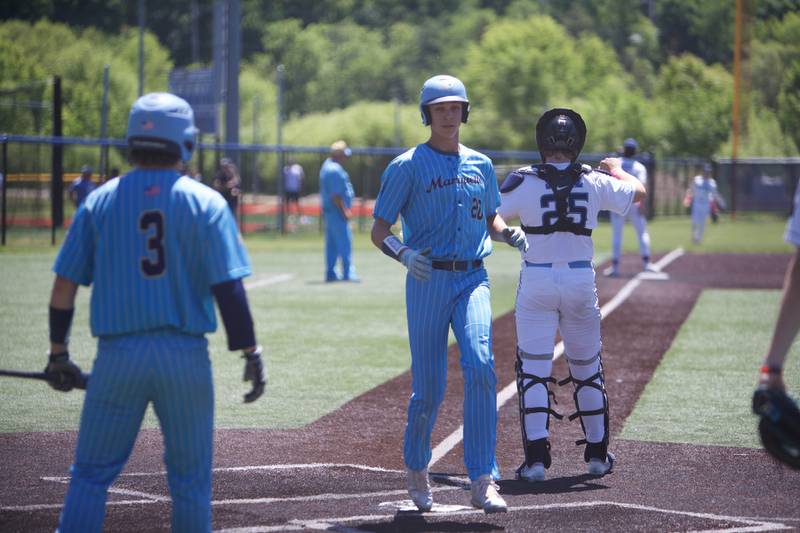Marquette's Charlie Mullen scores the winning run against Harvest Christian at the Class 1A Sectional Final on Saturday May 25, 2024 in Elgin.