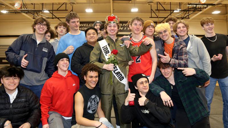 Nick Johnson (center) is surrounded by his posse after he is crowned Mr. Kaneland 2023 on Friday, March 10, 2023 in Maple Park.