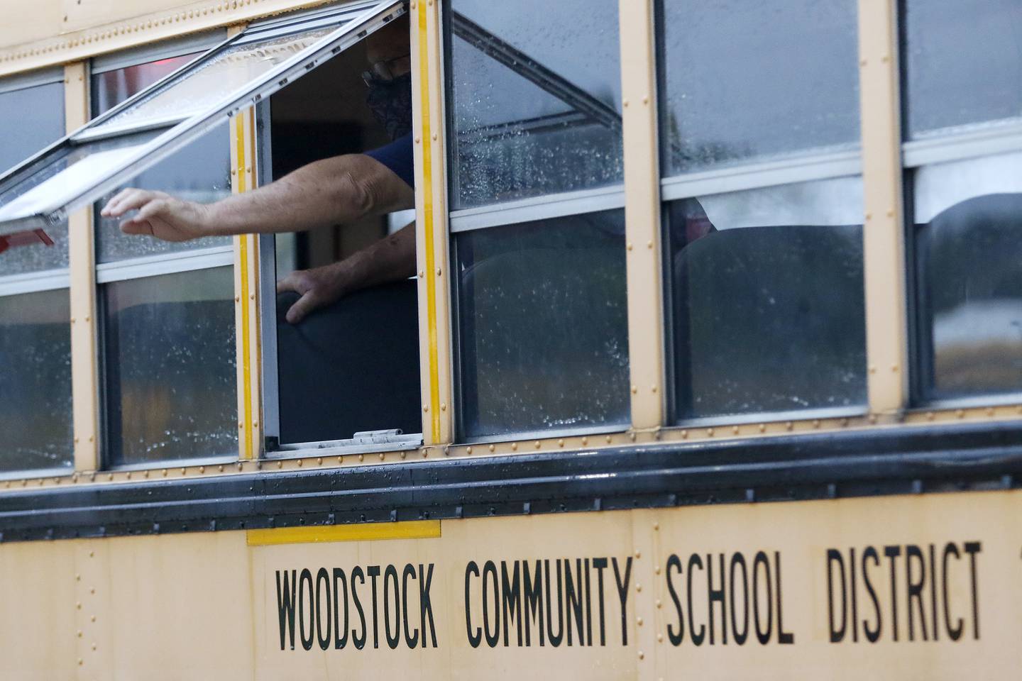 Woodstock Community Unit School District 200 school bus driver Bill Chrisos performs a routine pre-route safety check on his vehicle prior to leaving to pick students up for school on Tuesday, Oct. 5, 2021, in Woodstock.