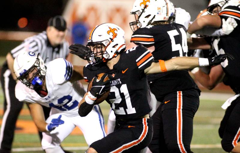 St. Charles East’s Mason Tousignant (21) runs the ball during a home game against Geneva on Friday, Sept. 30, 2022.