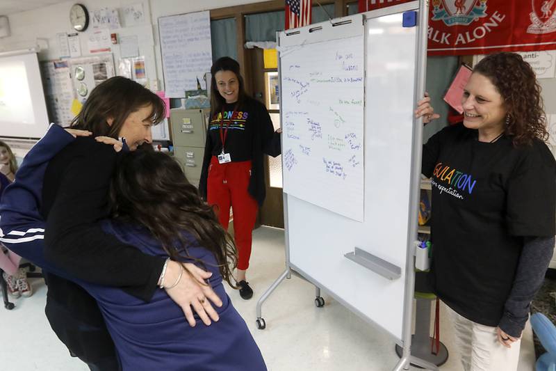 Teacher Kelly Schenk hugs fifth-grader Julissa Carette, as social worker Jenn Sanchez and social-emotional learning coordinator Kristen Ziemba reveal the nice things that Carette’s classmates wrote about her during a lesson about kindness on Tuesday, March 14, 2023, at South Elementary School in Crystal Lake.