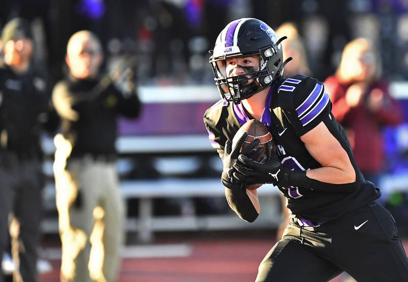 Downers Grove North's Charlie Cruse turns to the end zone after catching a long pass from quarterback Owen Lansu during an IHSA Class 7A semifinal game on Nov. 18, 2023 at Downers Grove North High School in Downers Grove .