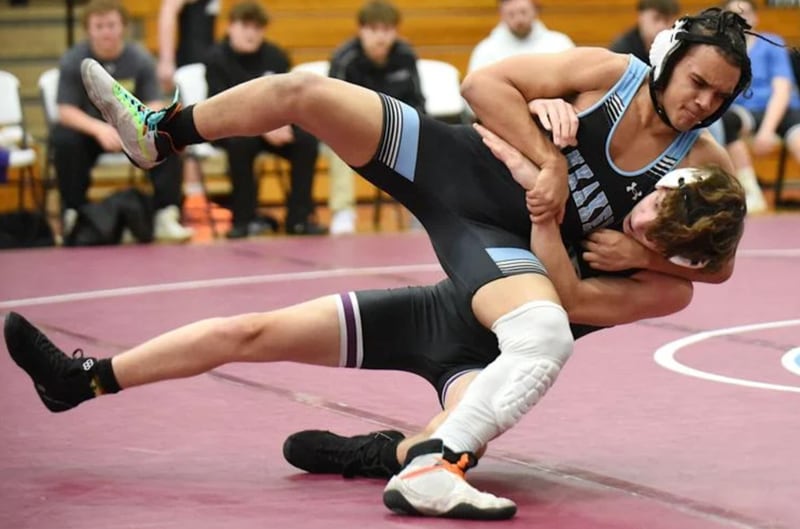 Kankakee's Sighel Lewis takes down Manteno's Nathan Kisala during Wednesday's All-City meet at Kankakee.