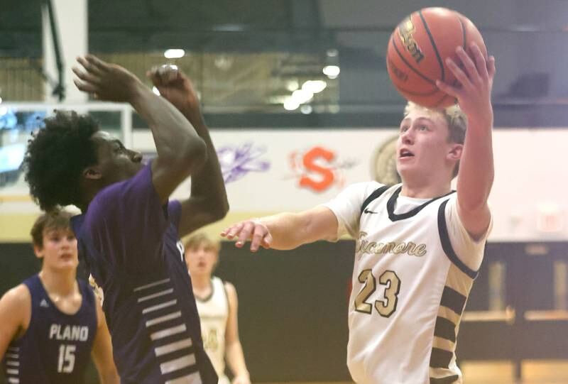 Sycamore's Carter York tries to get a shot around Plano’s Christ Keleba Tuesday, Jan. 3, 2023, during their game at Sycamore High School.