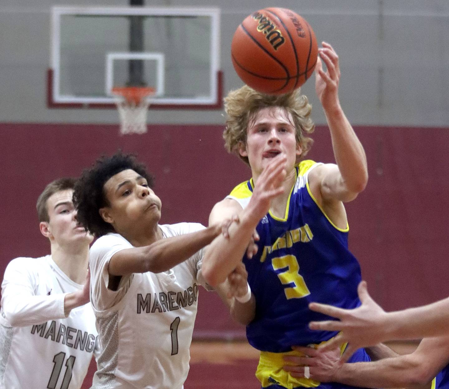 Marengo’s Exzavier Meyer, left, races Johnsburg’s Dylan Schmidt for the ball during varsity boys basketball at Marengo Thursday night.
