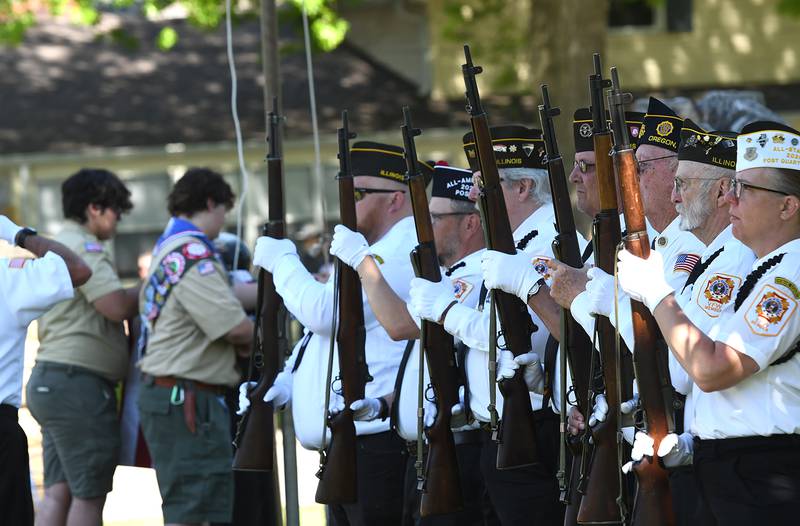 Oregon VFW members stand ready for the gun salute as Boy Souts raise the flag during Oregon's Memorial Day Service on Monday, May 25, 2026 at the Riverside Cemetery.