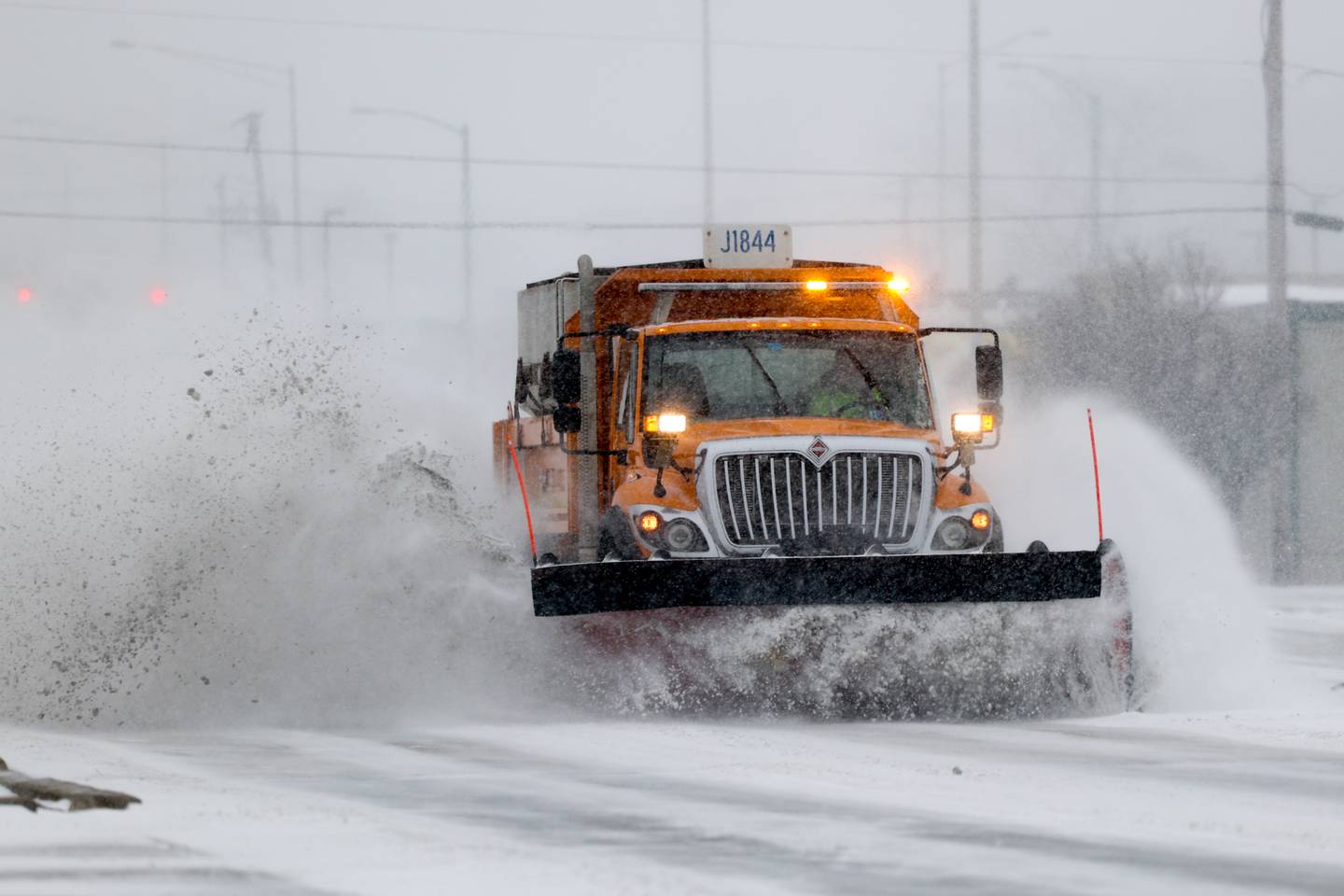 An IDOT snowplow clears along Plainfield Road in Joliet.