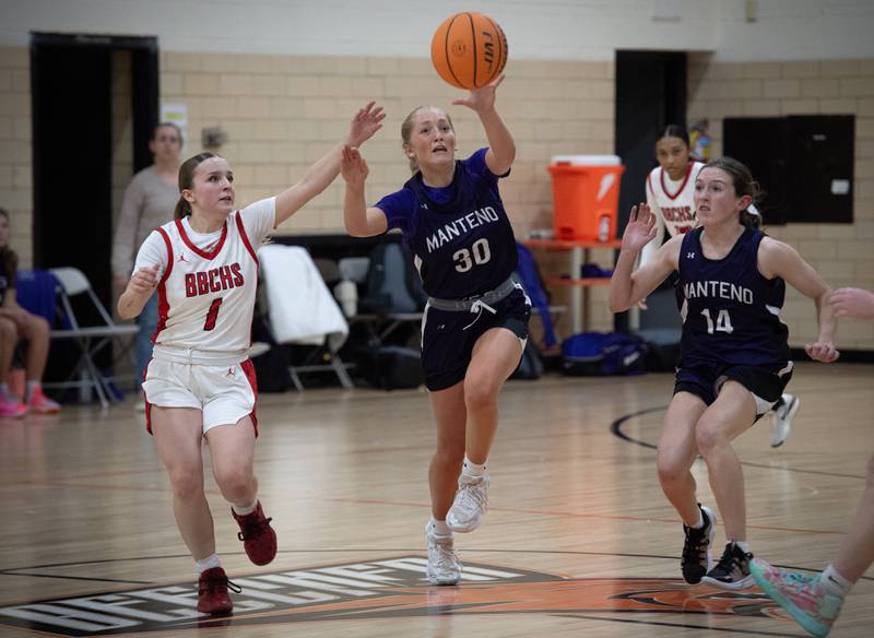 Manteno's Kendall Blanchette, center, recovers the ball over Bradley-Bourbonnais's Naturel Coday, left, and teammate Hannah Stritar, right, in the Beecher Fall Classic on Tuesday, November 18, 2025.
