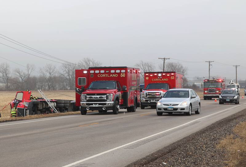 The west bound lane of Lincoln Highway is blocked as firefighters work to secure the cab of a semitrailer that rolled into the ditch Wednesday, Jan. 7, 2026, on the north side of Lincoln Highway in Cortland.