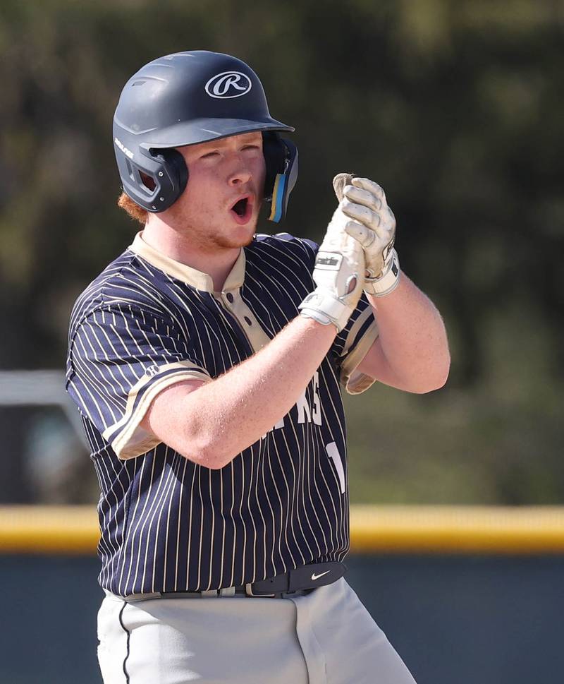 Hiawatha's Tommy Butler applauds after reaching second Tuesday, April 29, 2025, during their game against Hinckley-Big Rock at Hiawatha High School in Kirkland.
