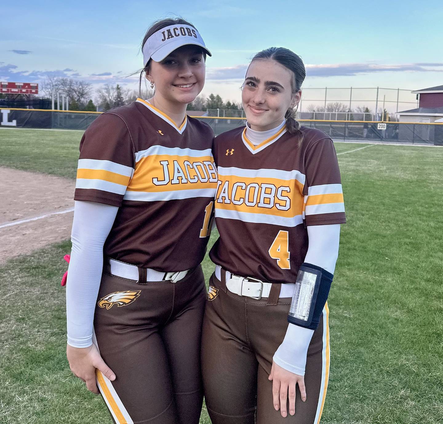Skylee Ferrante (left) struck out 12 batters in just over eight innings pitched and Emily Popilek (right) collected three RBIs to lead the  Jacobs softball team against Prairie Ridge.