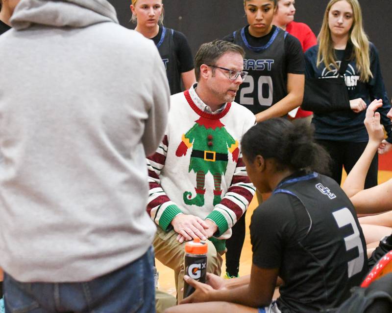 Oswego East's head coach Abe Carretto talks to the team between quarters on Thursday Dec. 18, 2025, while traveling to take on Yorkville High School.