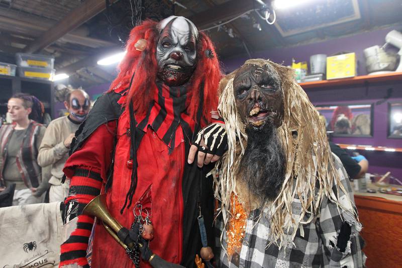 Martin Nelson, of Round Lake Beach (Dozer the Clown) and Zachary Hammett, of Lindenhurst (Scarecrow) pose for a picture before they greet guests who arrive at the Realm of Terror Haunted House in Round Lake Beach.