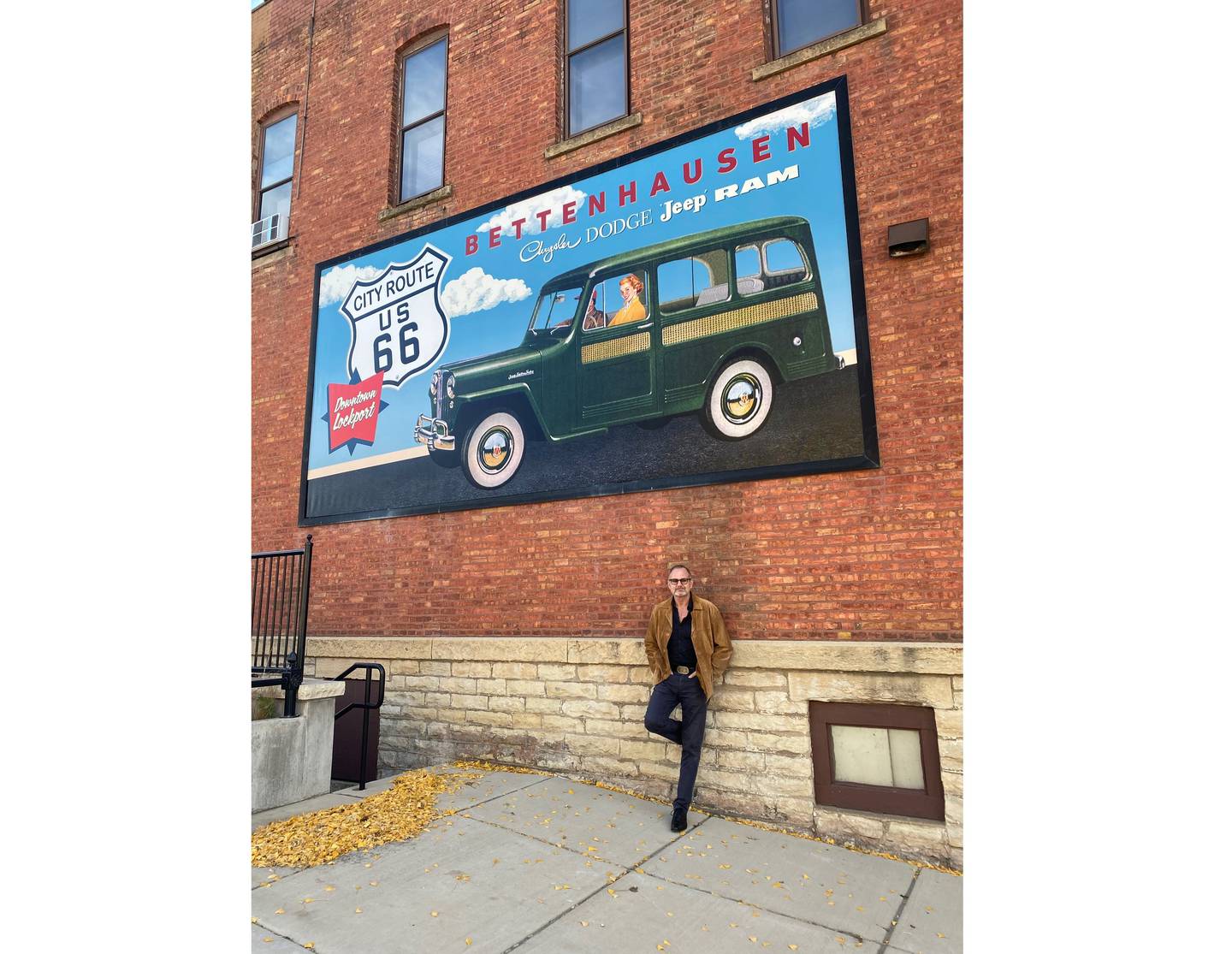 Steven Strait, mayor of Lockport, stands with one of two new murals he designed that will be unveiled at a ribbon cutting on Saturday in downtown Lockport. The ribbon cutting will also celebrate the completion of Lockport's StoryWalk.