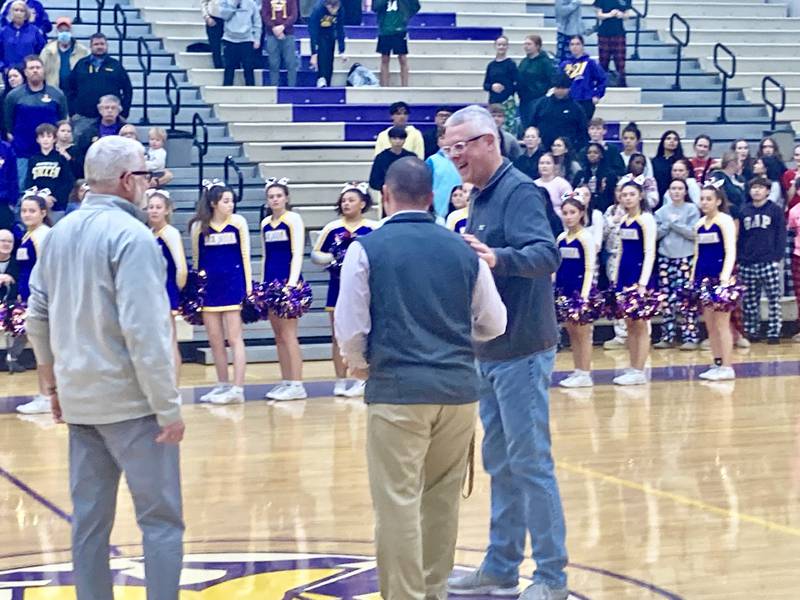 Kip Cheek, who has covered Mendota High School sports since 1984, received the IHSA Most Distinguished Media Award from Mendota Athletic Director Brock Zinker prior to Tuesday's varsity game with Rock Falls. Matt Troha of the IHSA was also in attendance to honor Cheek.