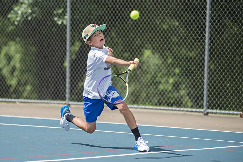 Braden Brigl returns a shot while playing in the 15 and under boys single tournament during the Emma Hubbs tennis classic in Dixon.