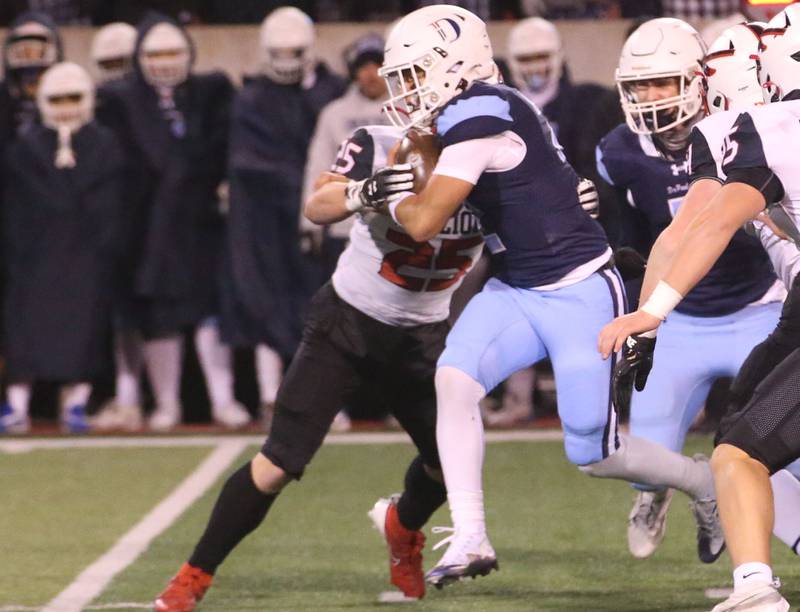 DePaul quarterback Juju Rodriguez runs the ball as hs is met by Mt. Zion's Kaden Becker during the Class 4A State football championship on Friday, Nov. 29, 2024 at Hancock Stadium in Normal.