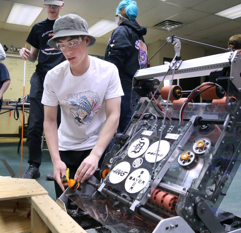 Nathan Tumminaro, a junior at DeKalb High School, takes some measurements on his team’s robot during a Crowbotics team meeting Tuesday, April 10, 2024, at Huntley Middle School in DeKalb. Crowbotics is DeKalb High School’s robotics team who has qualified to compete in the FIRST Robotics Competition World Championship held in Houston, Texas April 17-20.