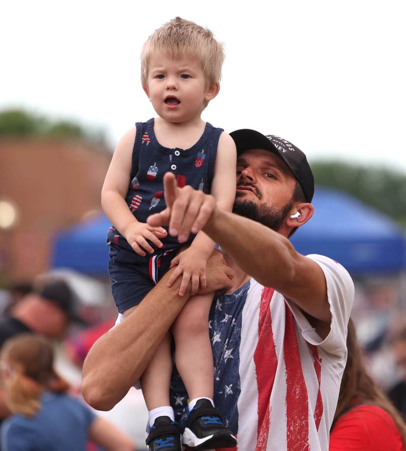 Christopher Bruno and his son Elias, 2, from Rochelle spot the parade as it begins its trip down Main Street Friday, July 4, 2025, during the Fourth of July parade in downtown Kirkland.