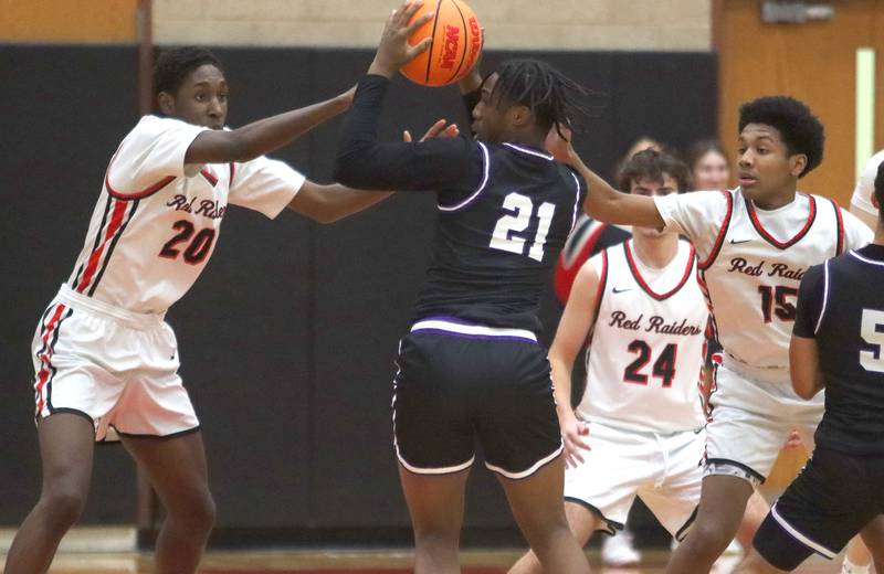 Huntley’s Isaiah Onu, left, and Isaac Muze, right, pressure Hampshire’s Treysan Simmons in varsity boys basketball on Friday, Dec. 19, 2025, at Huntley High School in Huntley.