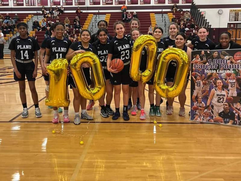 Plano players celebrate Josie Larson (23) scoring her 1,000th career point on Wednesday at Richmond-Burton.