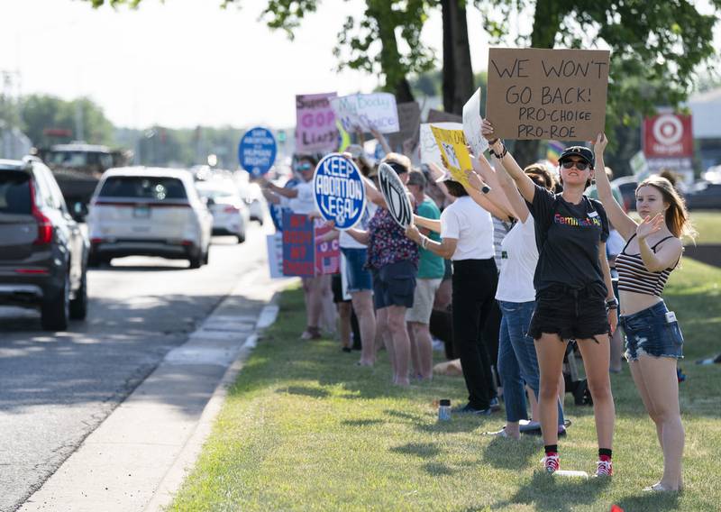 Protestors line up Friday, June 24, 2022, along Route 14 near Exchange Drive in Crystal Lake during a protest over the overturning of Roe v. Wade, organized by the McHenry County National Organization for Women. On Friday, the U.S. Supreme Court overturned the decades-old ruling that upheld the right to an abortion.