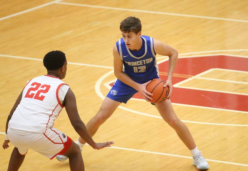 Princeton's Tyson Phillips looks to pass the ball while being guarded by Ottawa's Tristan Finley during the Dean Riley Shootin' The Rock Thanksgiving Tournament on Monday, Nov. 20, 2023 at Kingman Gym.