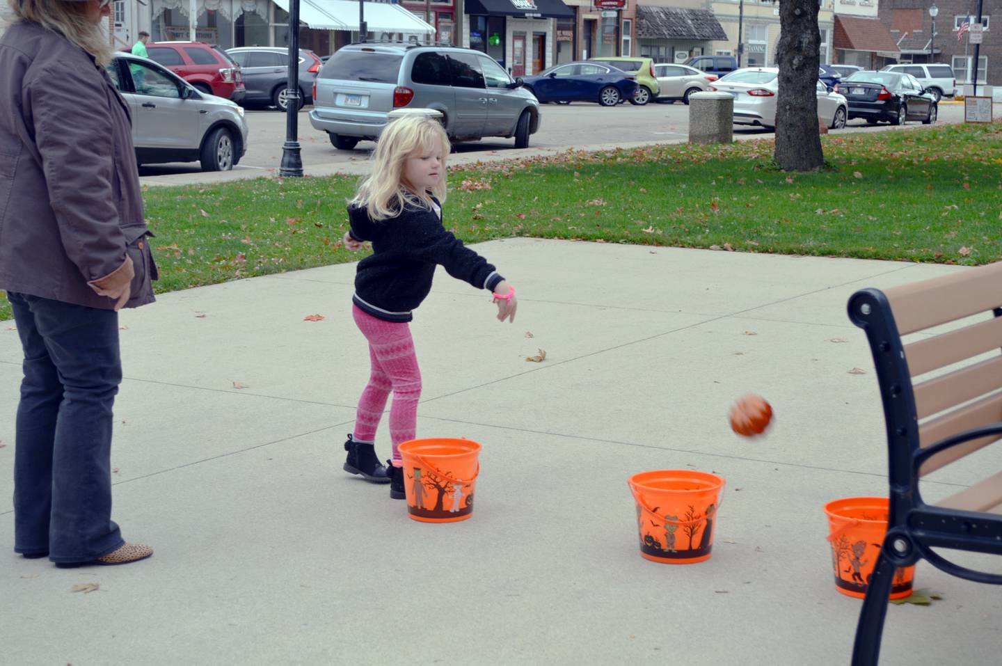 Tegan Turner, 5, of Mt. Morris, tosses a toy pumpkin into a bucket as part of a penny carnival game during the Family Fall Festival at the Mt. Morris village square on Oct. 16. This was the festival's first year; it serves as an additional fundraiser for the Let Freedom Ring Fourth of July fireworks.