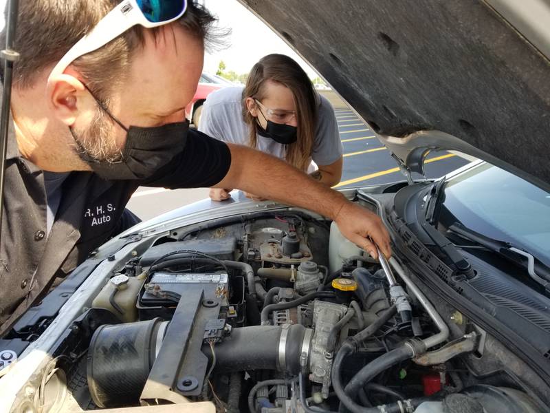 Romeoville High School autos teacher Pete Morris instructs students during class.